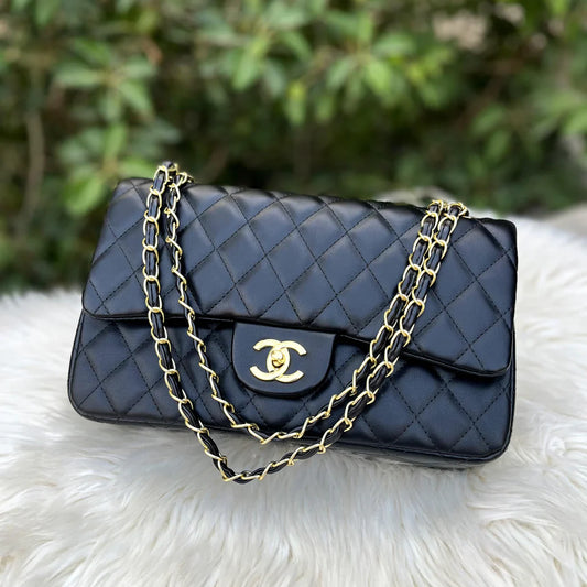 CHANEL Classic Double Flap Bag in black quilted leather, a luxury handbag for women with timeless style.